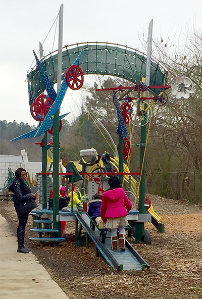 Kids play on a playground outside.