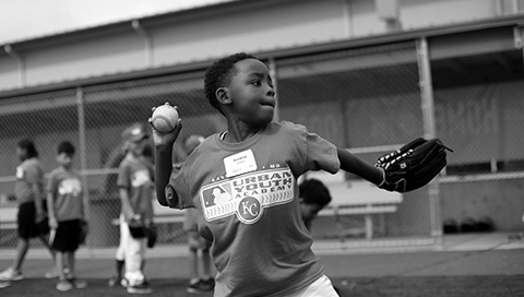 A young boy in mid-pitch
