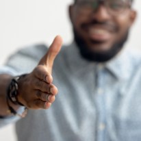 An African-American businessman reaches out for a handshake