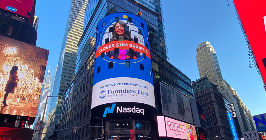 A screen on the Nasdaq building in Times Square reads: "Closes $11M Series A. The inclusive economy is here. Founders First Capital Partners.
