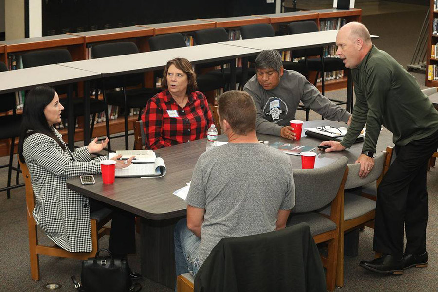 A group of five participants in conversation during a NetWork Kansas E-Community Ice House series convening.