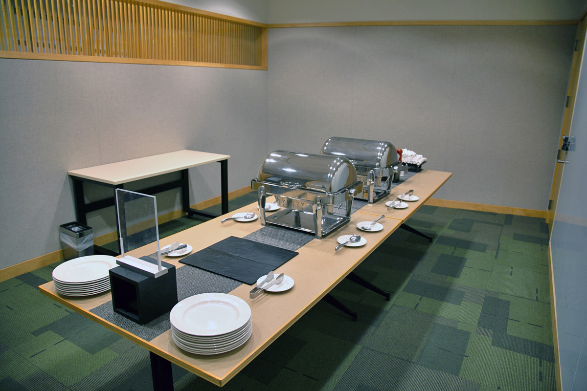 A smaller conference room with a buffet table, which connects to an adjoining meeting room.