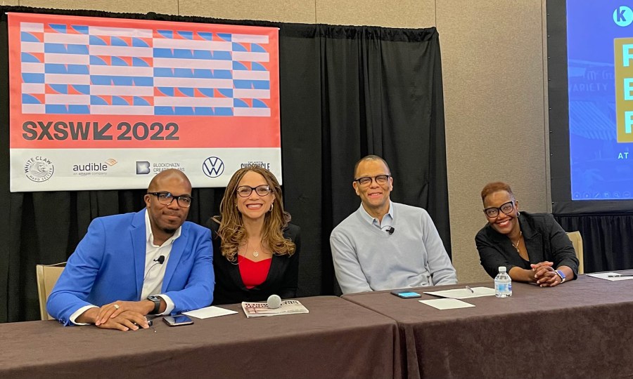 Four panelists pose for a photo at their table at SXSW 2022 in March.