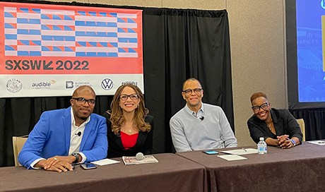 Four panelists pose for a photo at their table at SXSW 2022 in March.