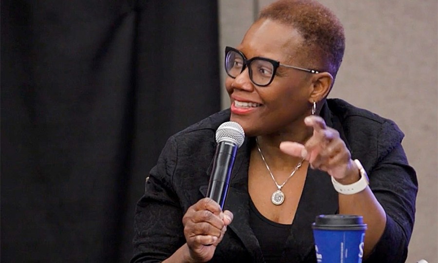 A photo of Karen Freeman-Wilson speaking into a microphone