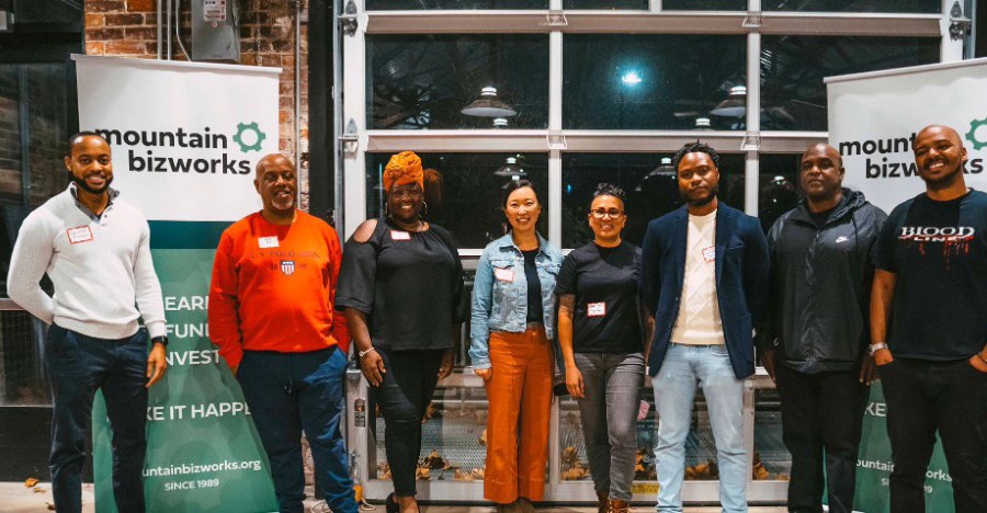 Eight people stand for a group photo in Asheville, North Carolina, at a Mountain BizWorks event.