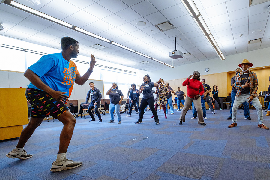 Amplify attendees do a quick workout, following the lead of the fitness instructor at the front of the room.