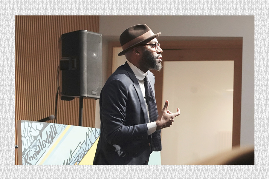 Dr. Christopher Emdin speaking on stage at Amplify.