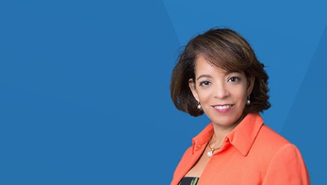 A photo of Alejandra Y. Castillo on top of a blue background.