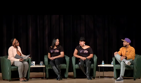 A panel of four Black entrepreneurs sit on stage