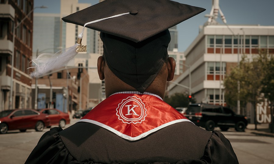 A 2021 Kauffman Scholars graduate stands in the middle of a Kansas City, Missouri, street.