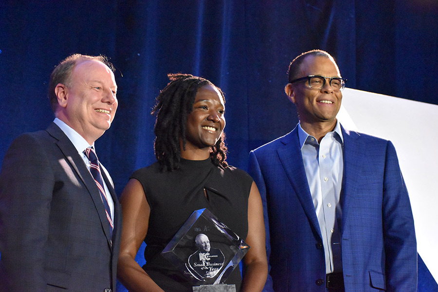 Fahteema Parrish, president and founder of Parris & Sons Construction, poses for a photo holding the Mr. K Award she received at the KC Chamber Small Business Celebration. She is joined by Joe Reardon from the Greater Kansas City Area Chamber of Commerce, and Philip Gaskin from the Ewing Marion Kauffman Foundation.