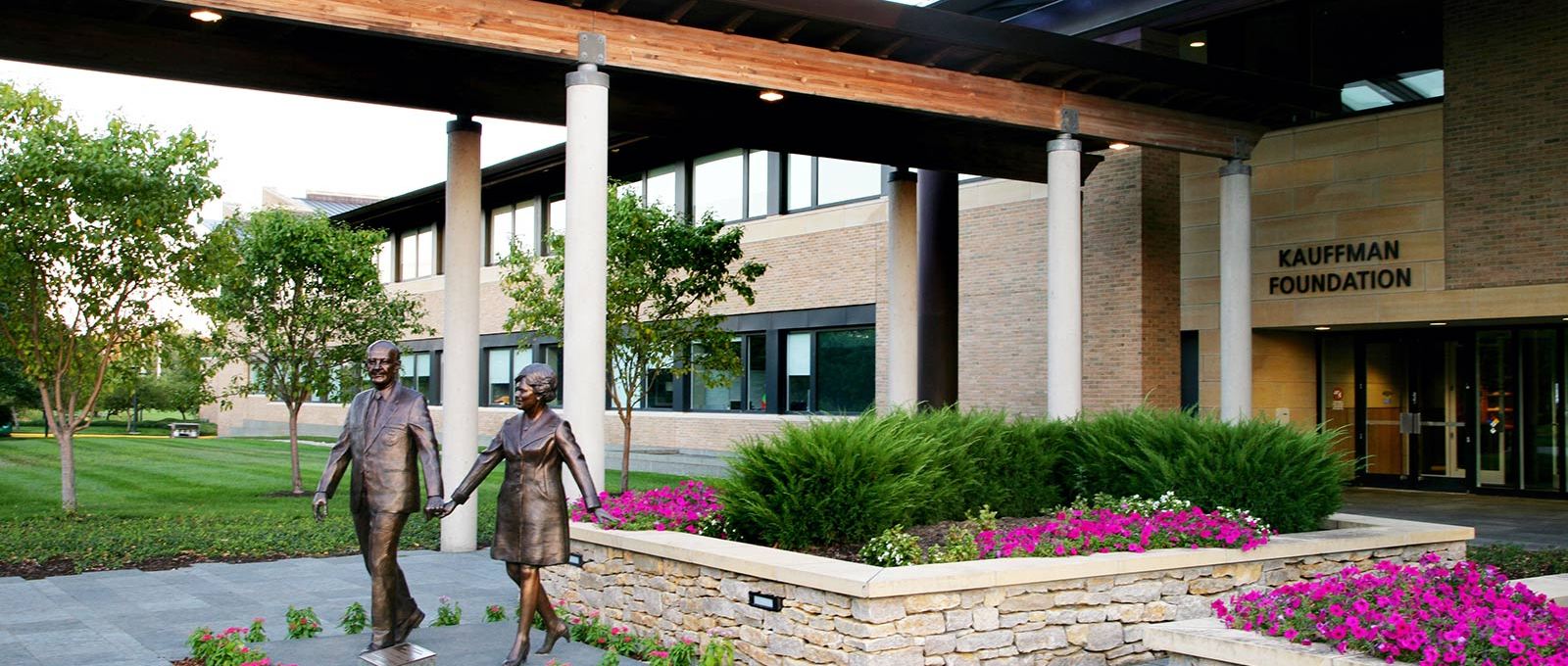 The front entrance of the Ewing Marion Kauffman Foundation features two bronze statues of Mr. and Mrs. Kauffman.
