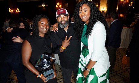 Three people pose for a photo at the Greater Kansas City Chamber of Commerce Small Business Celebration: Fahteema Parrish, left, holds the "Mr. K Award" in her hands; Daniel Smith stands in the center; and Shakia Webb is to the right.