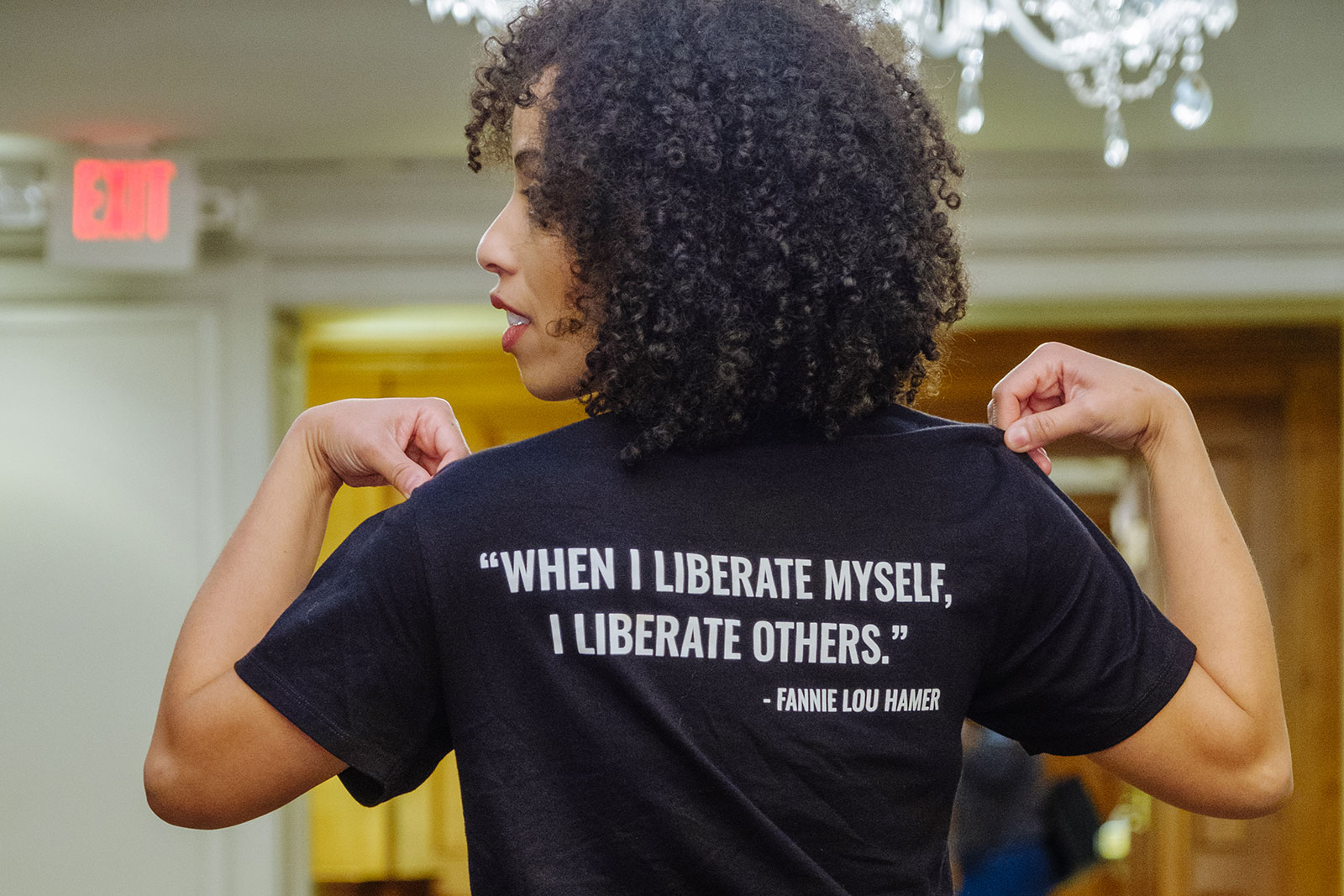 Dena Simmons from LiberatED wears a t-shirt that reads on the back: "'When I liberate myself, I liberate others.' – Fannie Lou Hamer"