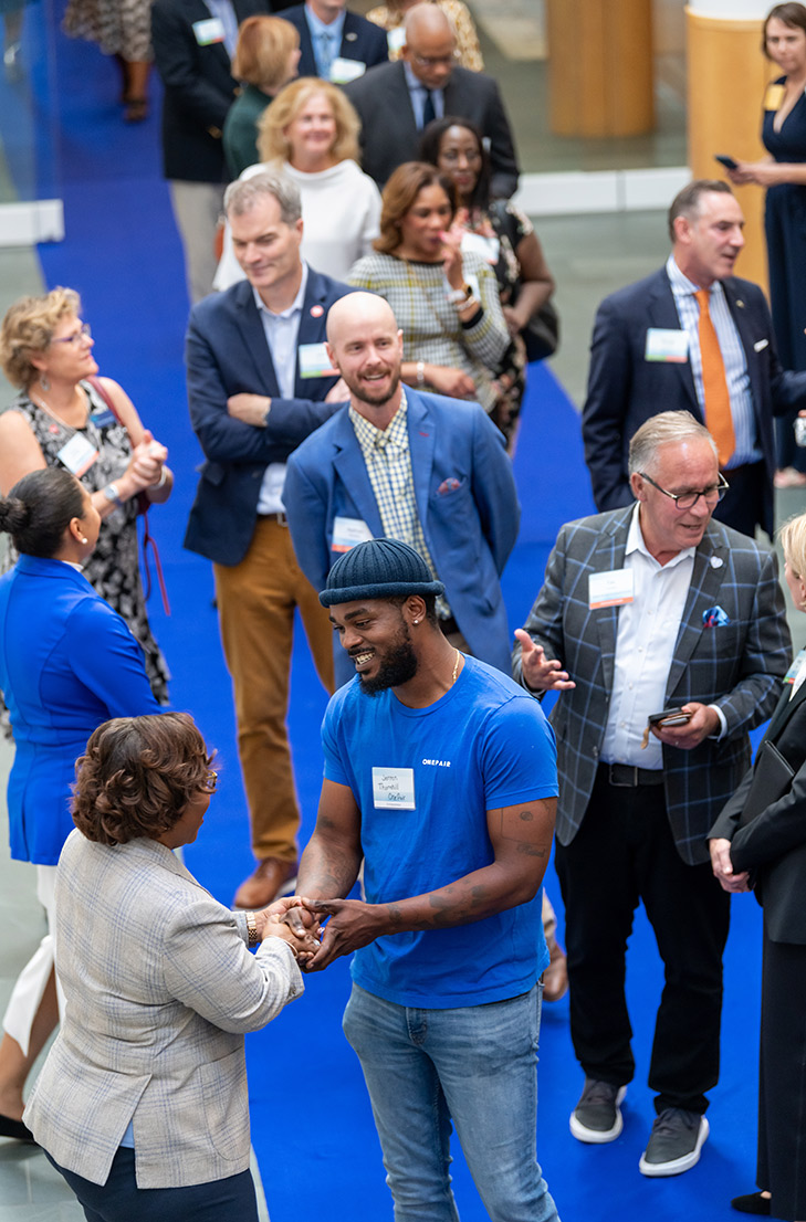 Dr. DeAngela Burns-Wallace greets community members at the end of the blue carpet at the Kauffman Foundation's Open House event Sept. 28, 2023.