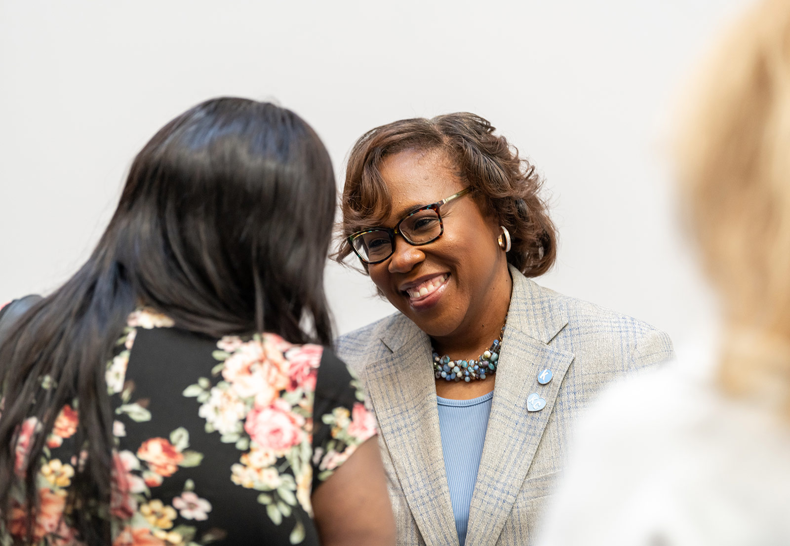 Dr. DeAngela Burns-Wallace greets community members at the end of the blue carpet at the Kauffman Foundation's Open House event Sept. 28, 2023.