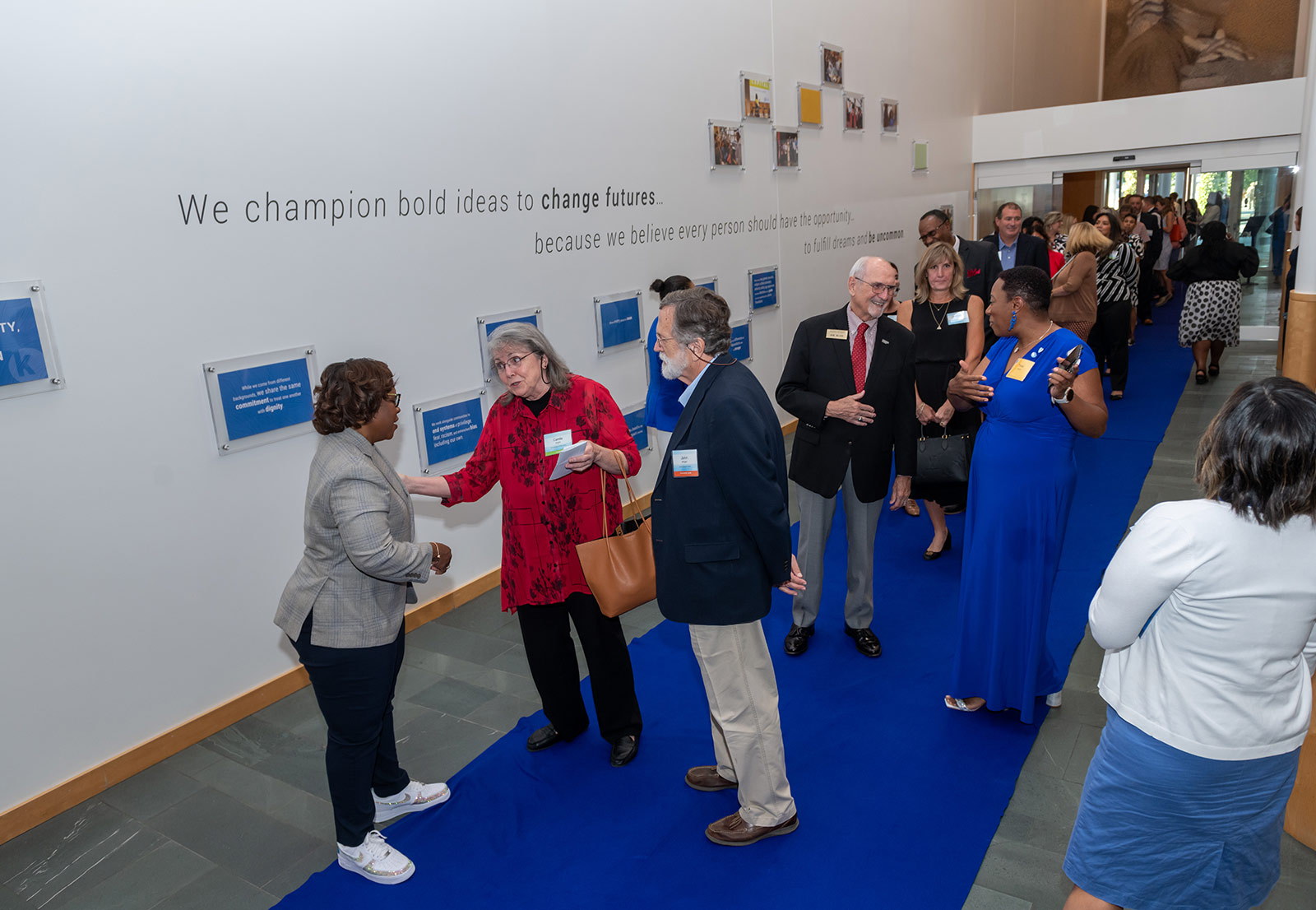 Dr. DeAngela Burns-Wallace greets community members at the end of the blue carpet at the Kauffman Foundation's Open House event Sept. 28, 2023.