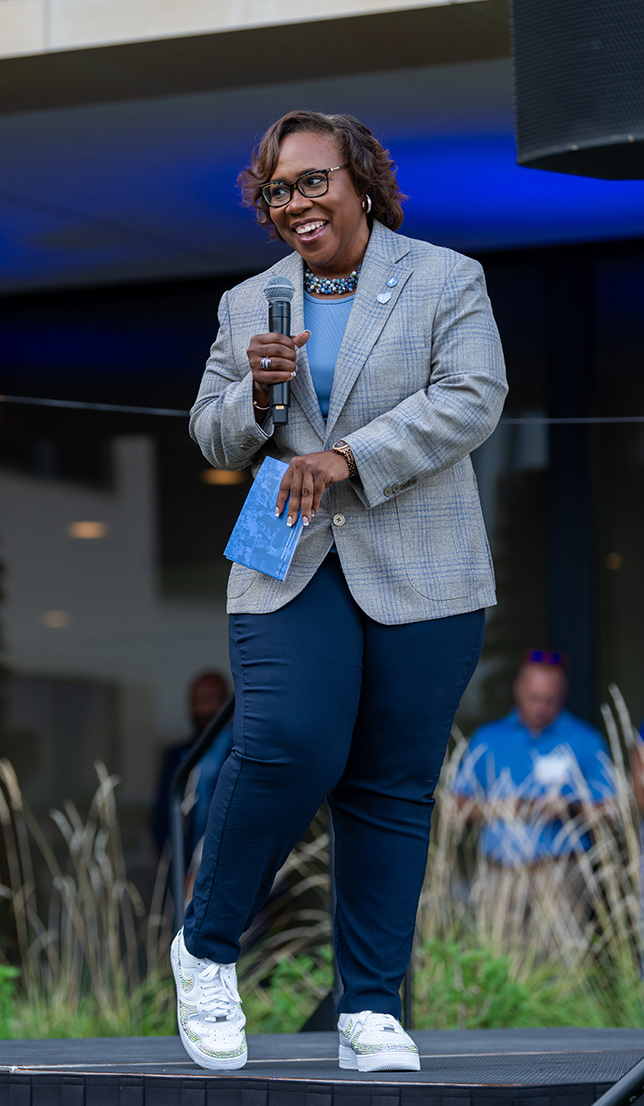 Dr. DeAngela Burns-Wallace shows off her custom shoes from OnePair KC at the Kauffman Foundation Open House event Sept. 28, 2023.
