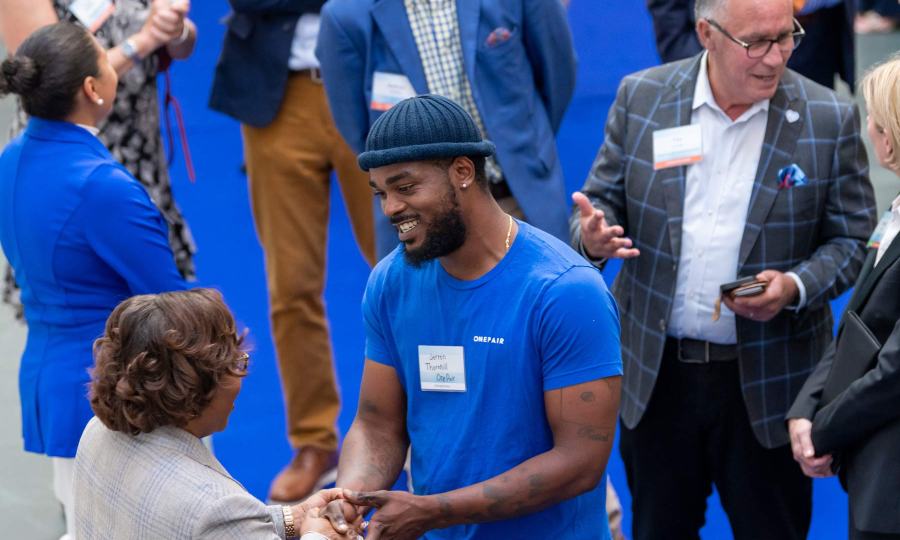 Dr. DeAngela Burns-Wallace greets community members at the end of the blue carpet at the Kauffman Foundation's Open House event Sept. 28, 2023.