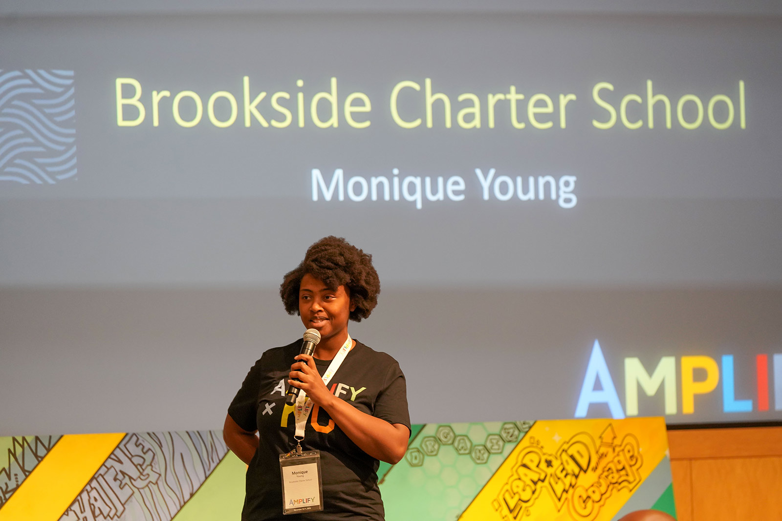 Monique Young from Brookside Charter School speaks during the 2023 Amplify Conference