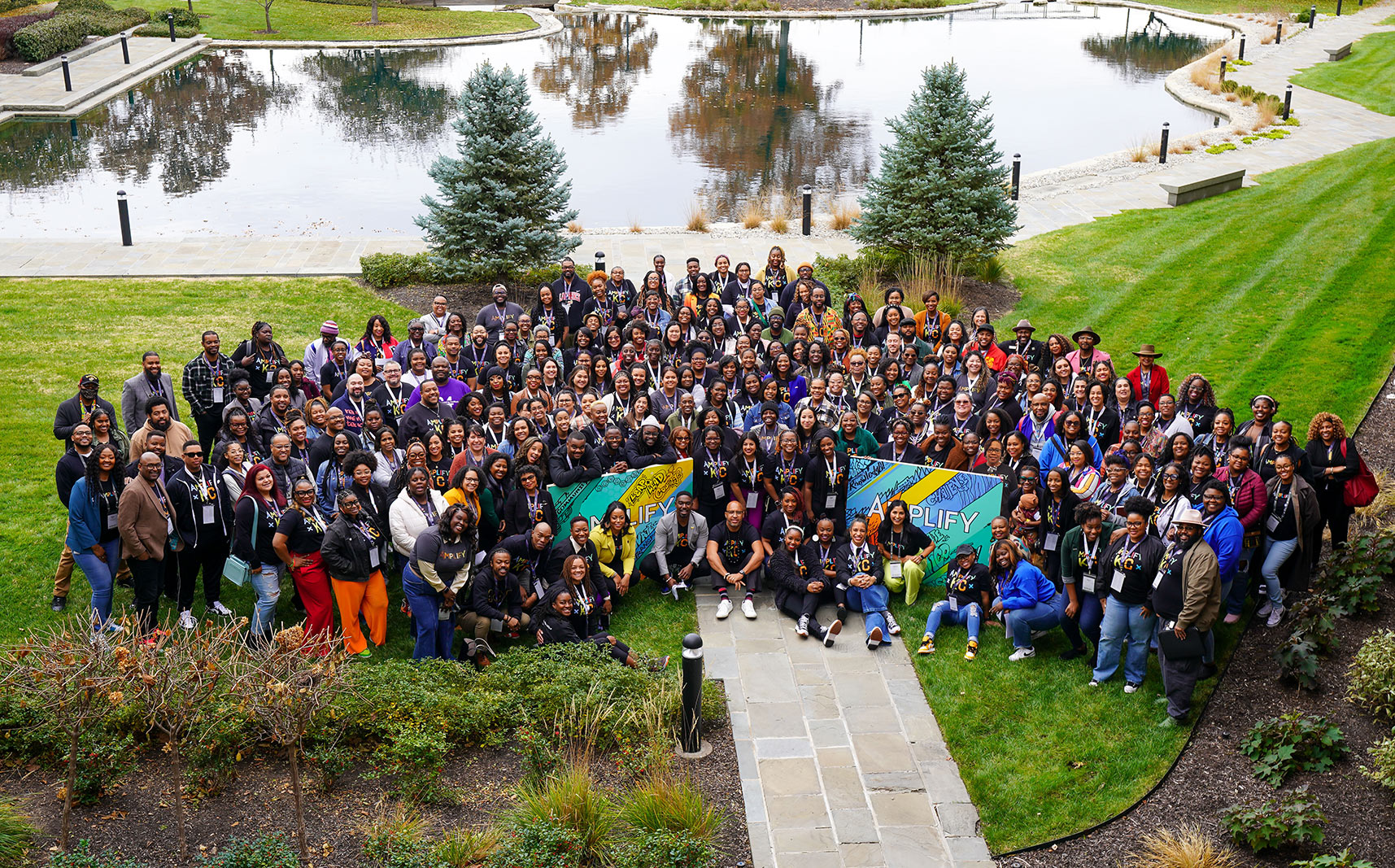 Amplify 2023 attendees pose for a group photo outside