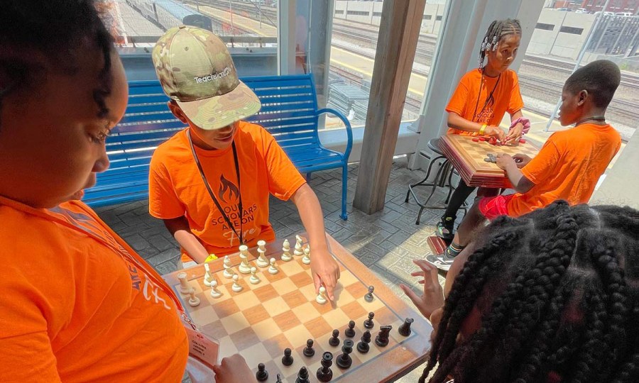 Kansas City young people play a game of chess after school