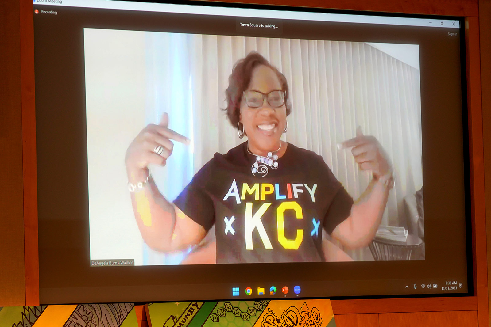 Dr. DeAngela Burns-Wallace, president and CEO of the Kauffman Foundation, joins Amplify 2023 via Zoom wearing an Amplify KC shirt.