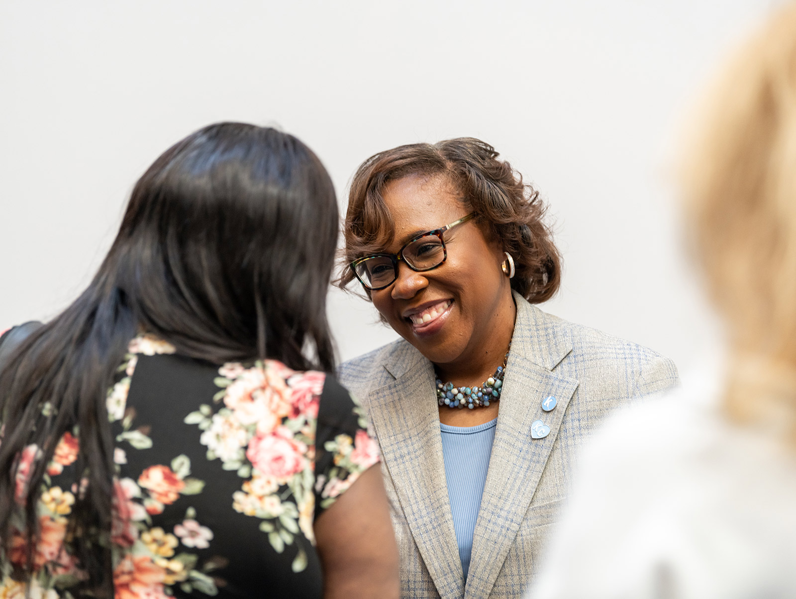 Dr. DeAngela Burns-Wallace greets community member at the Kauffman Foundation Open House