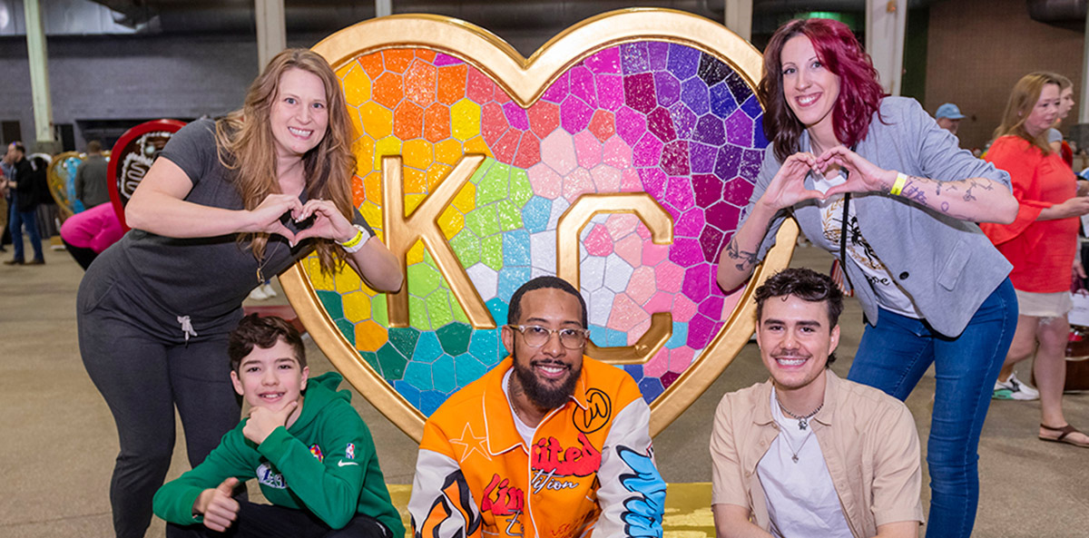 Parade of Hearts artists pose in front of the 'Takes Heart' heart by Laura Noll Crossley at the Parade of Hearts reveal event on April 13.