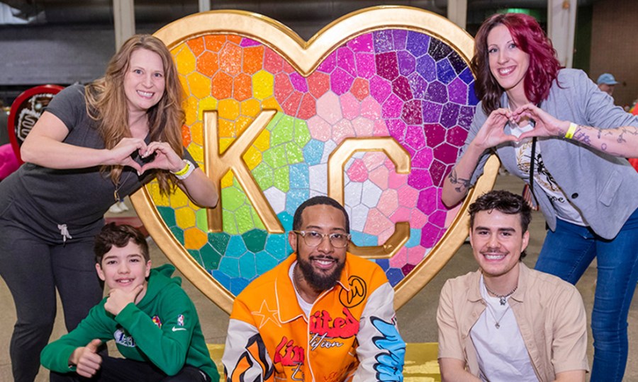 Parade of Hearts artists pose in front of the 'Takes Heart' heart by Laura Noll Crossley at the Parade of Hearts reveal event on April 13.