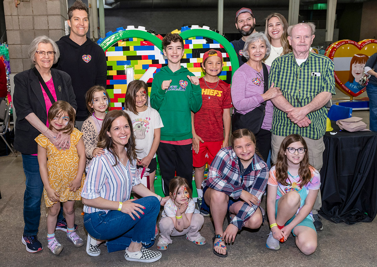 Parade of Hearts artist Campbell Wayne Dean poses with his heart, 'Brick by Brick', with family and friends at the American Royal Governor's Expo event on April 13.