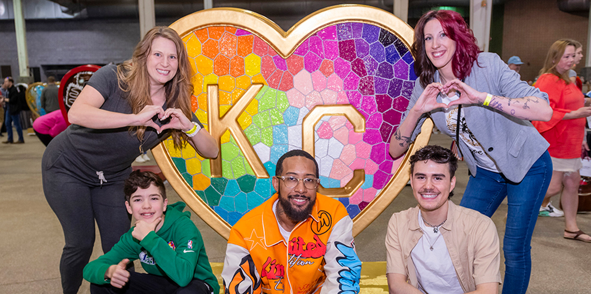 Artists, from left, Laura Noll Crossley, Campbell Wayne Dean, John Pannell, Luke Broste, and Megan Boyce, pose in front of the 'Takes Heart' heart by Laura Noll Crossley at the Parade of Hearts reveal event on April 13.