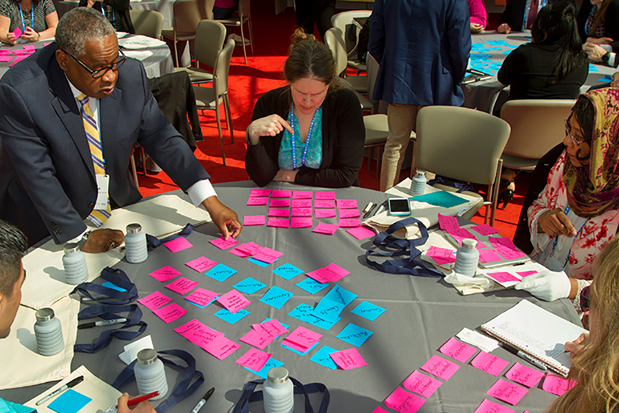 Collaboration with post-it notes around a table
