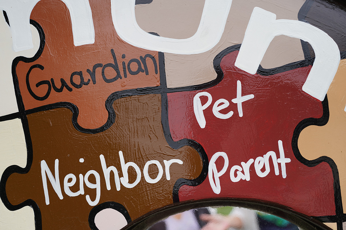 The "CommUnity Through Common Unity" Heart shows puzzle pieces with different identities, such as "guardian", "neighbor", and "pet parent"