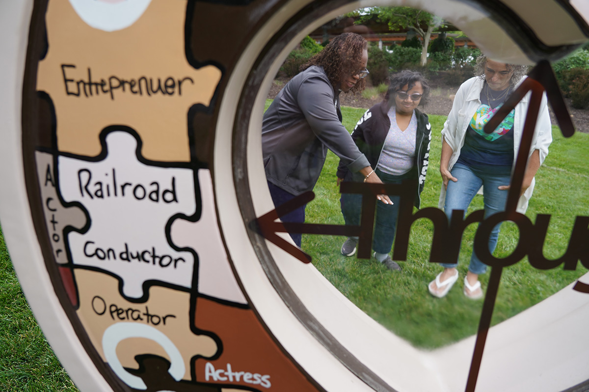 Dr. DeAngela Burns-Wallace, Jenn Vogel, and Alana Anderson with the "CommUnity Through Common Unity" Heart