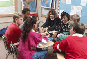 Students around a table with a teacher