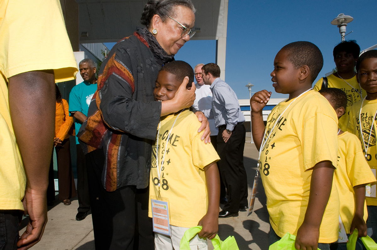 A teacher hugs a student