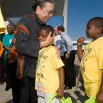 A teacher hugs a student