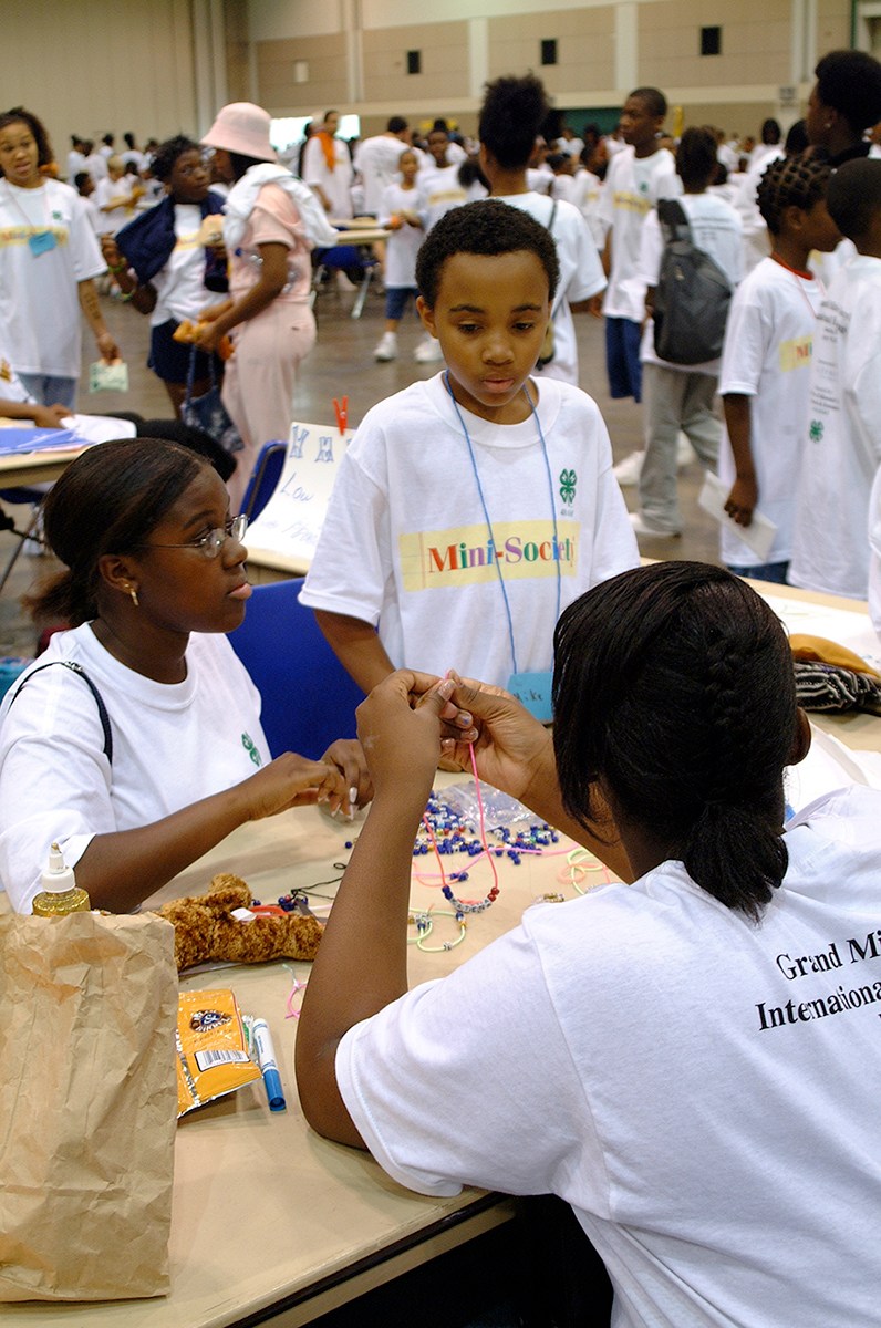 A group of young adults make necklaces at the Grand Mini-Society International Exchange Day hosted by the University of Missouri.